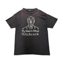 UNDERCOVER ALFRED HITCHCOCK TEE.