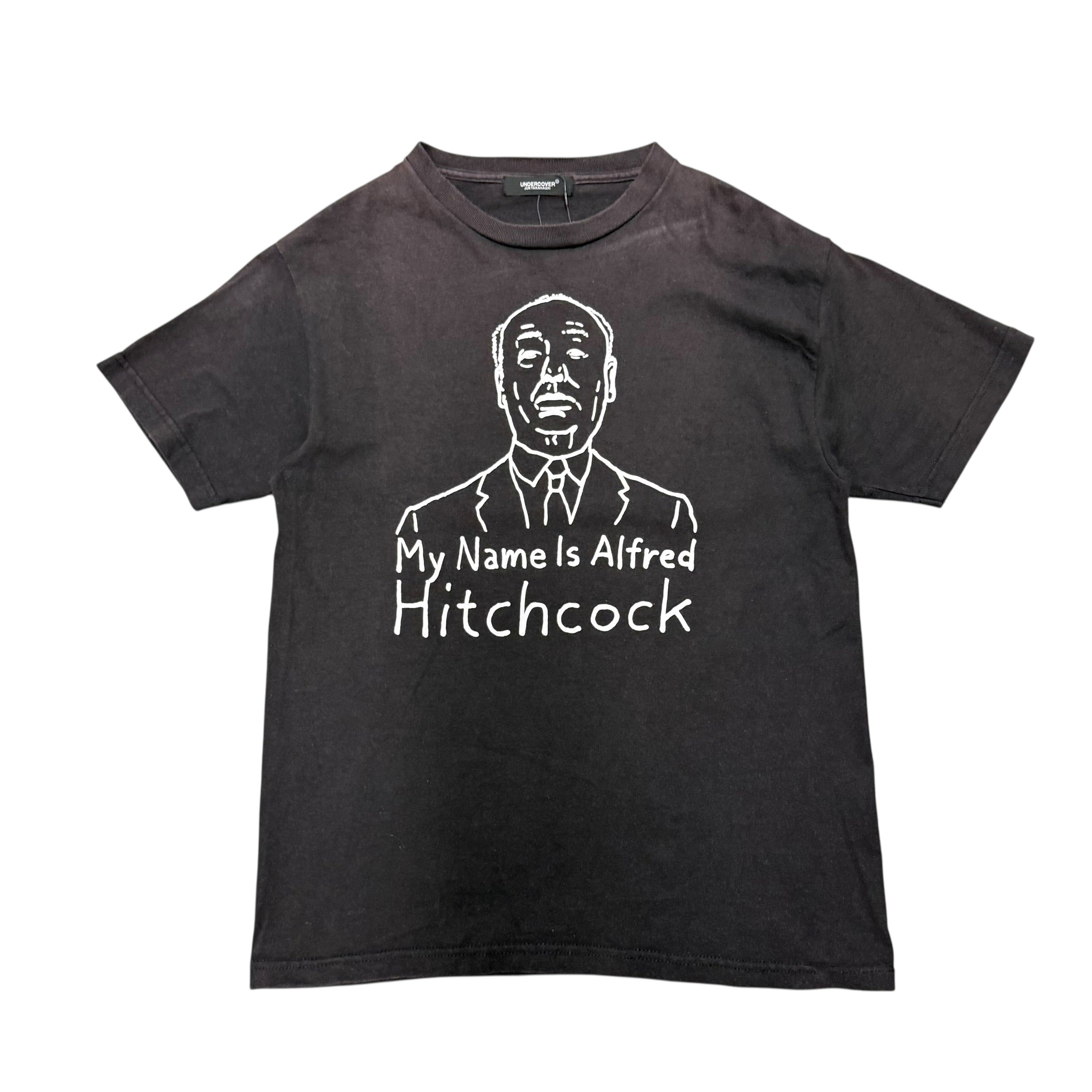 UNDERCOVER ALFRED HITCHCOCK TEE.