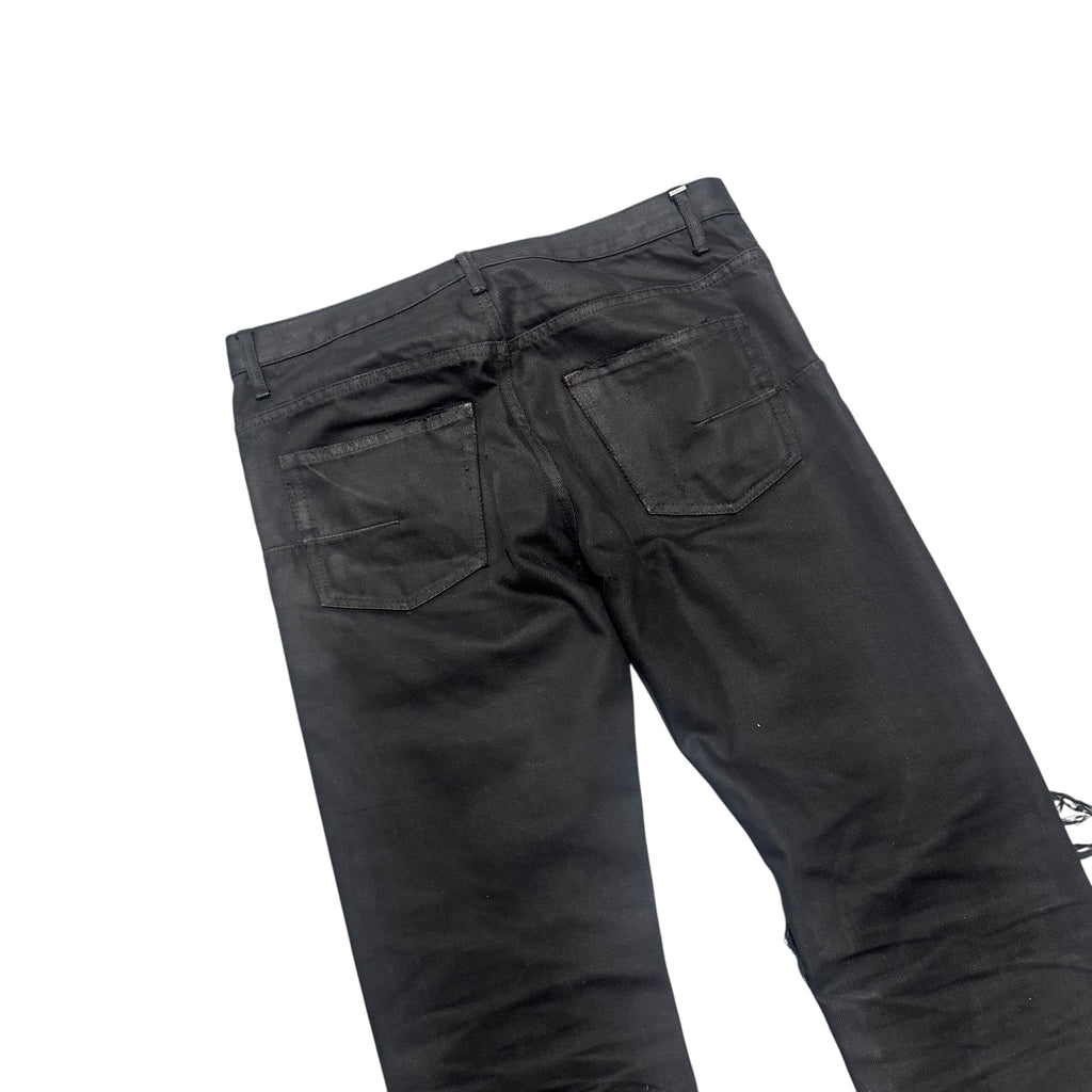 DIOR DISTRESSED BLACK WAXED DENIM PANTS.