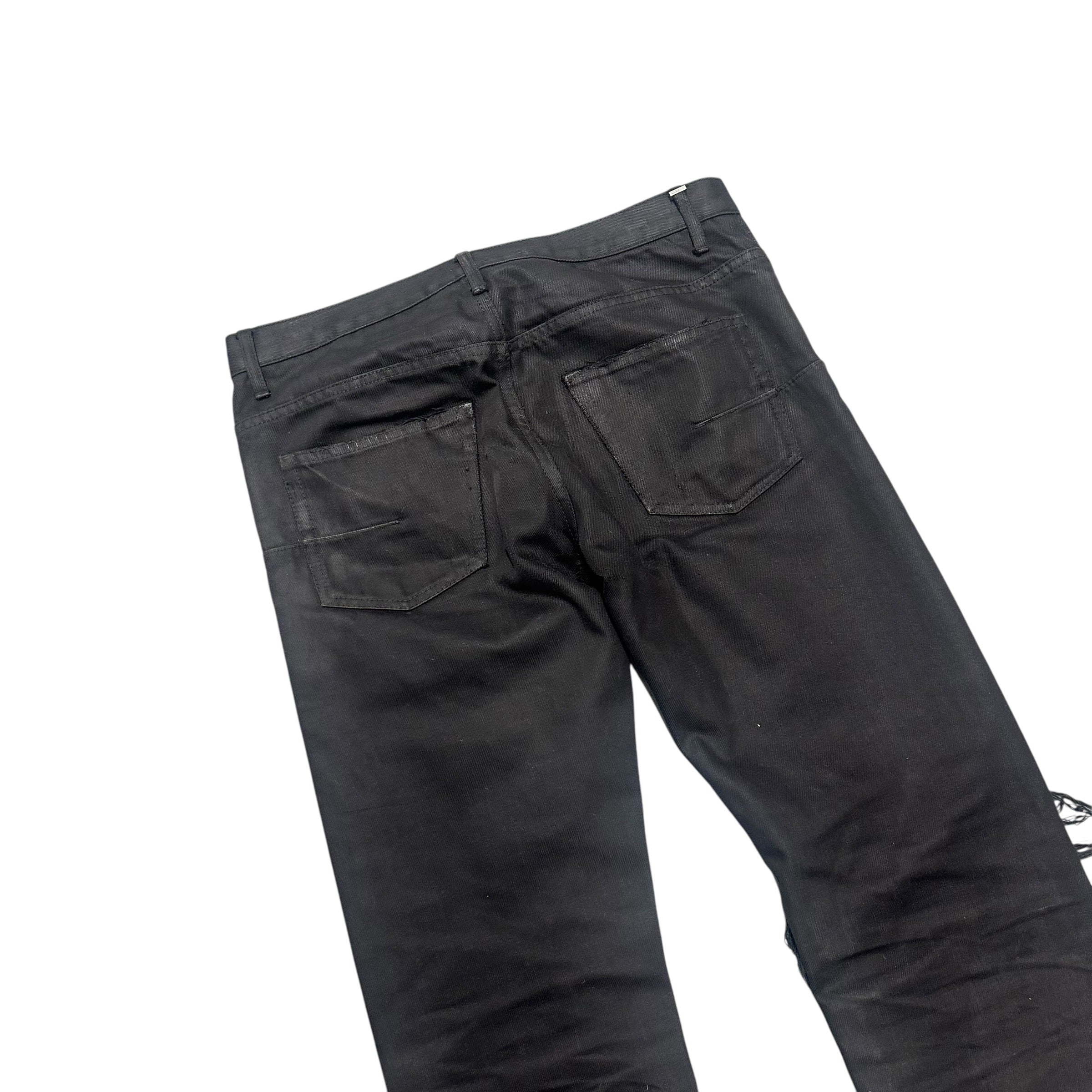 DIOR DISTRESSED BLACK WAXED DENIM PANTS.