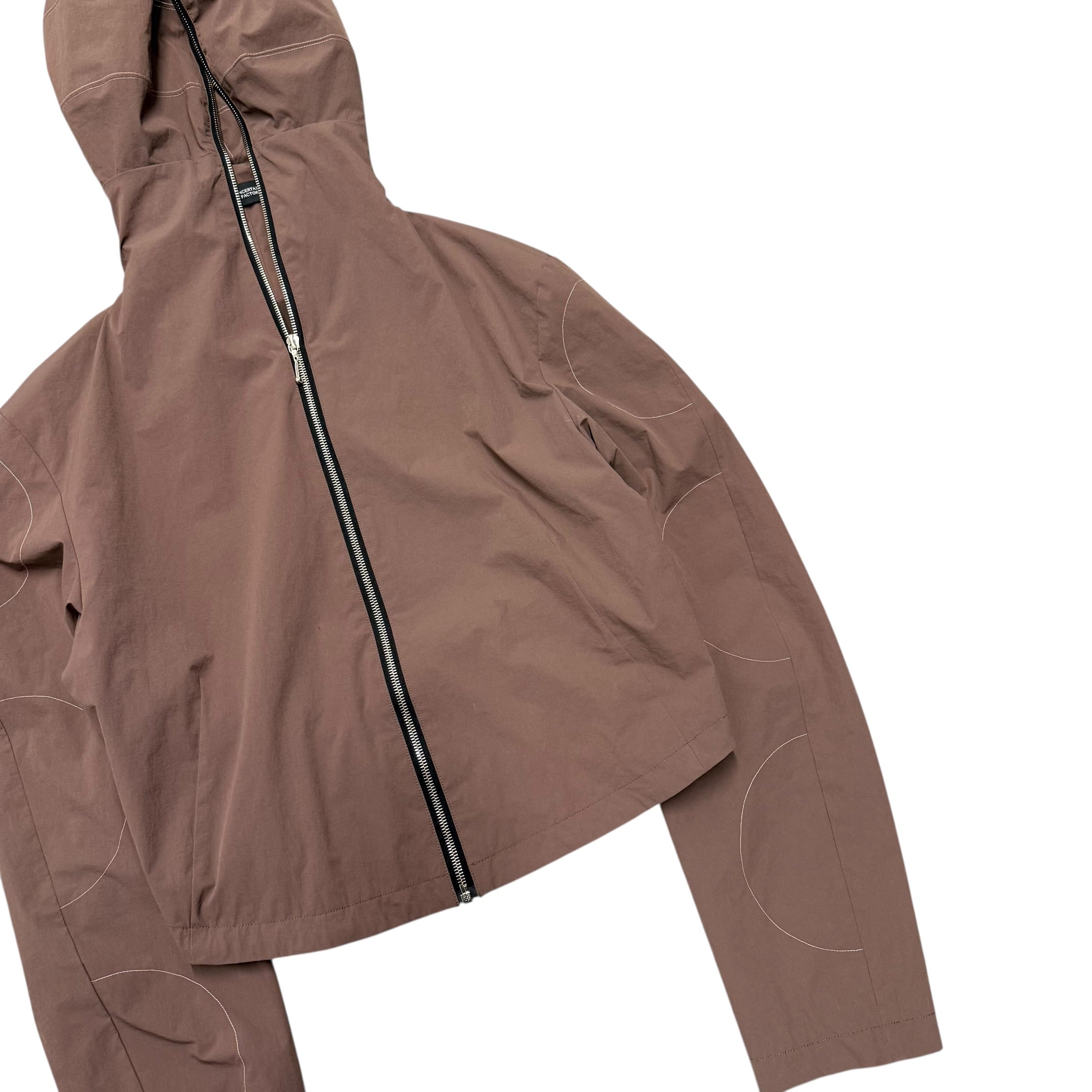 UNCERTAIN FACTOR BROWN ZIP UP NYLON JACKET.