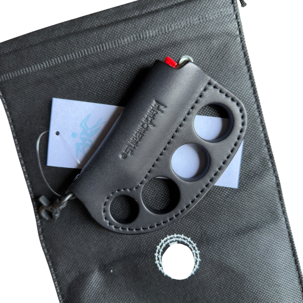 BLACK MEANS BRASS KNUCKLE LEATHER LIGHTER.
