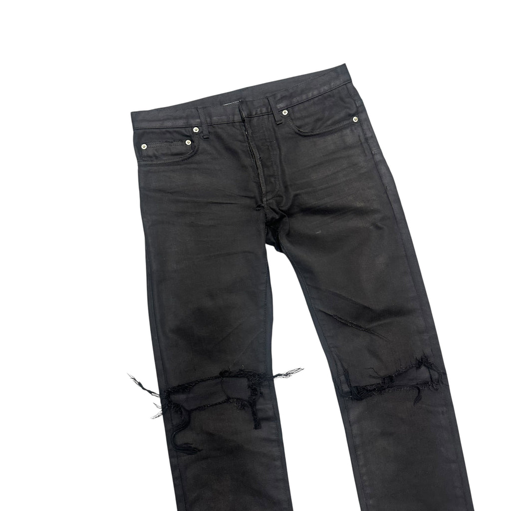 DIOR DISTRESSED BLACK WAXED DENIM PANTS.